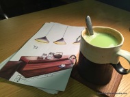 Hot Matcha Latte next to menu; Uchi